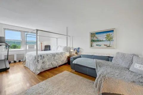 a bedroom with a bed and a couch