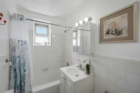 a bathroom with a bathtub a shower and a sink