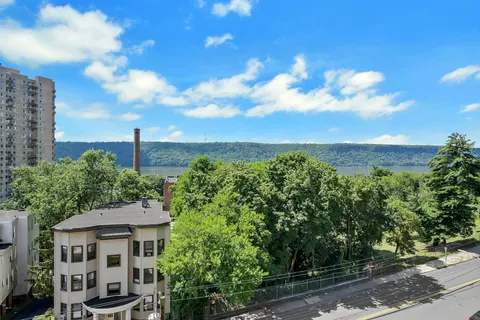 a view of a house with a yard and sitting area