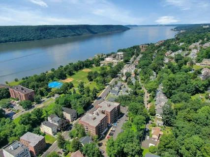an aerial view of a house with a yard and lake view