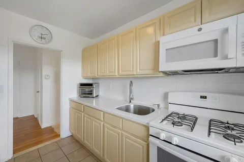 a kitchen with stainless steel appliances granite countertop a sink and cabinets