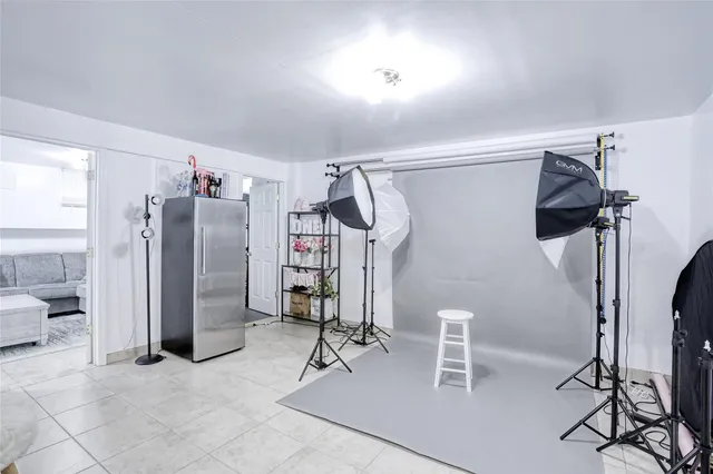 a room with gym equipment and refrigerator