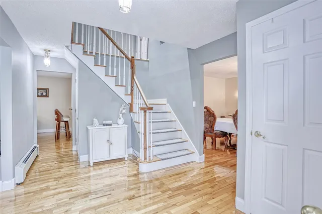 a view of entryway and hall with wooden floor
