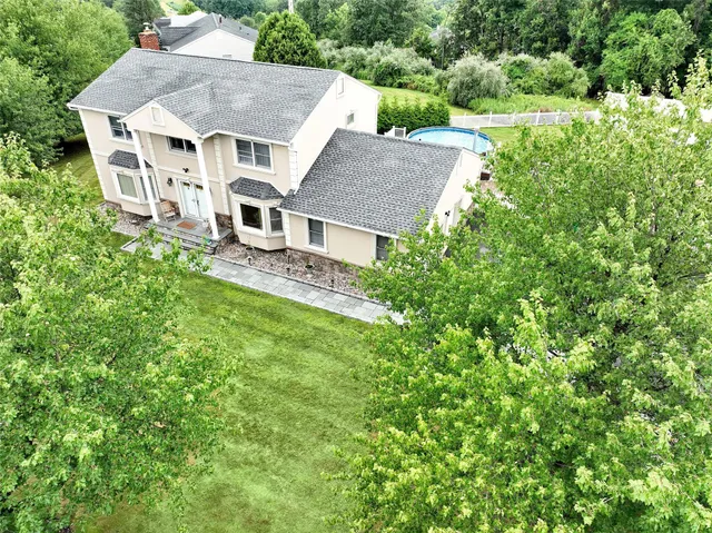 an aerial view of a house with a yard table and chairs