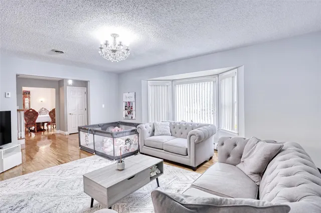 a living room with furniture and a chandelier