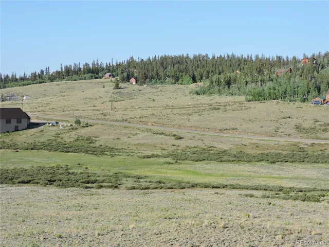 a view of a lake with houses in the back