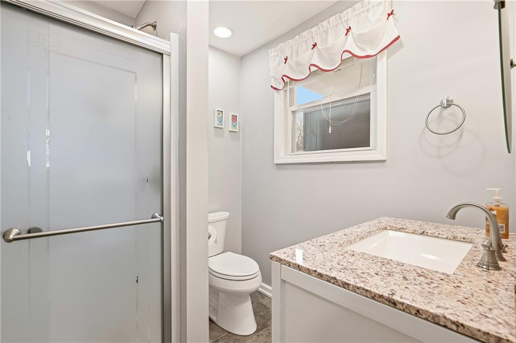 276 Glessner Road Johnstown, PA 15905 - Photo 14 of 36 a bathroom with a granite countertop sink mirror vanity and toilet