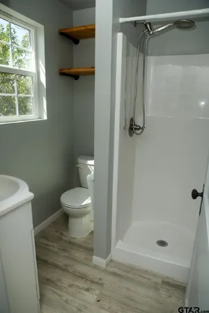 a bathroom with a toilet and a shower