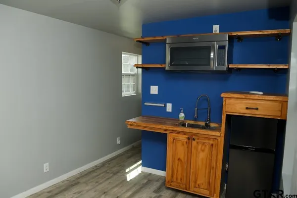 a kitchen with stainless steel appliances wooden cabinets and a stove top oven