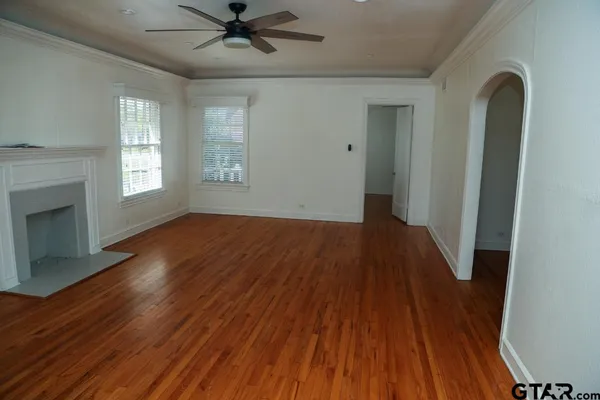 wooden floor in an empty room with a fireplace