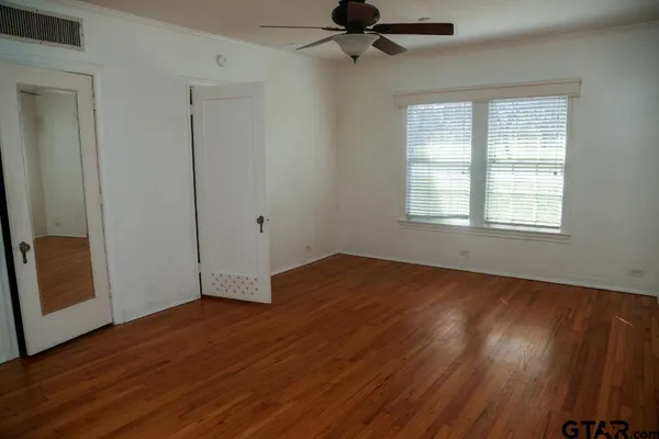 wooden floor in an empty room with a window