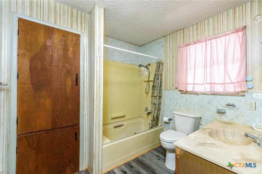 921 Robertson Gonzales, TX 78629 - Photo 13 of 31 a bathroom with a sink a toilet and shower
