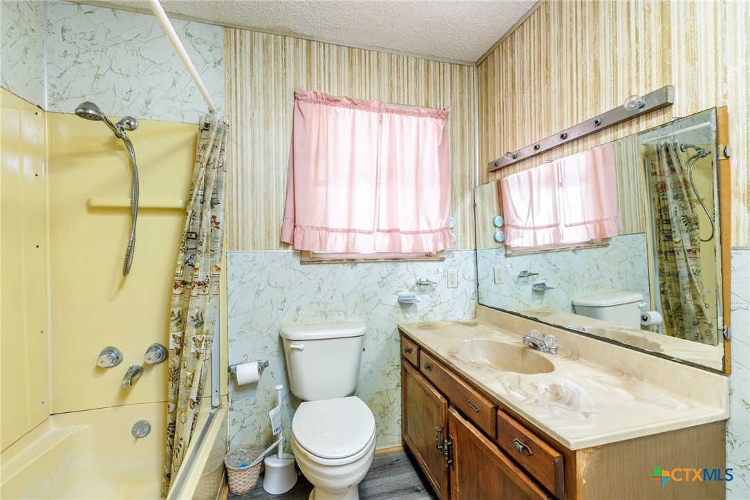 921 Robertson Gonzales, TX 78629 - Photo 14 of 31 a bathroom with a sink a toilet and a shower