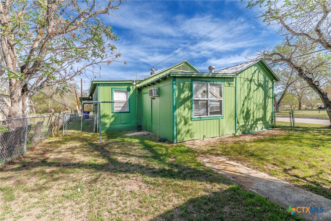 921 Robertson Gonzales, TX 78629 - Photo 28 of 31 a view of a brick house next to a yard with large trees