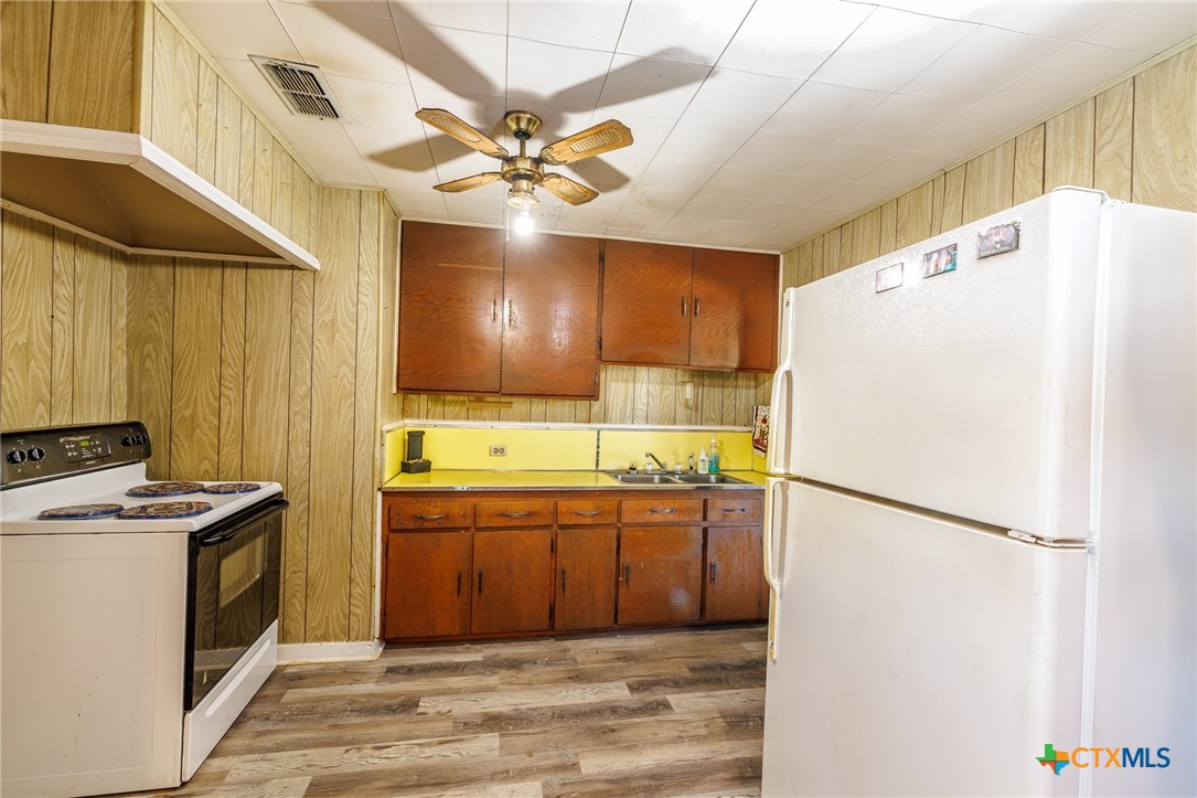 921 Robertson Gonzales, TX 78629 - Photo 6 of 31 a kitchen with stainless steel appliances a refrigerator and a sink