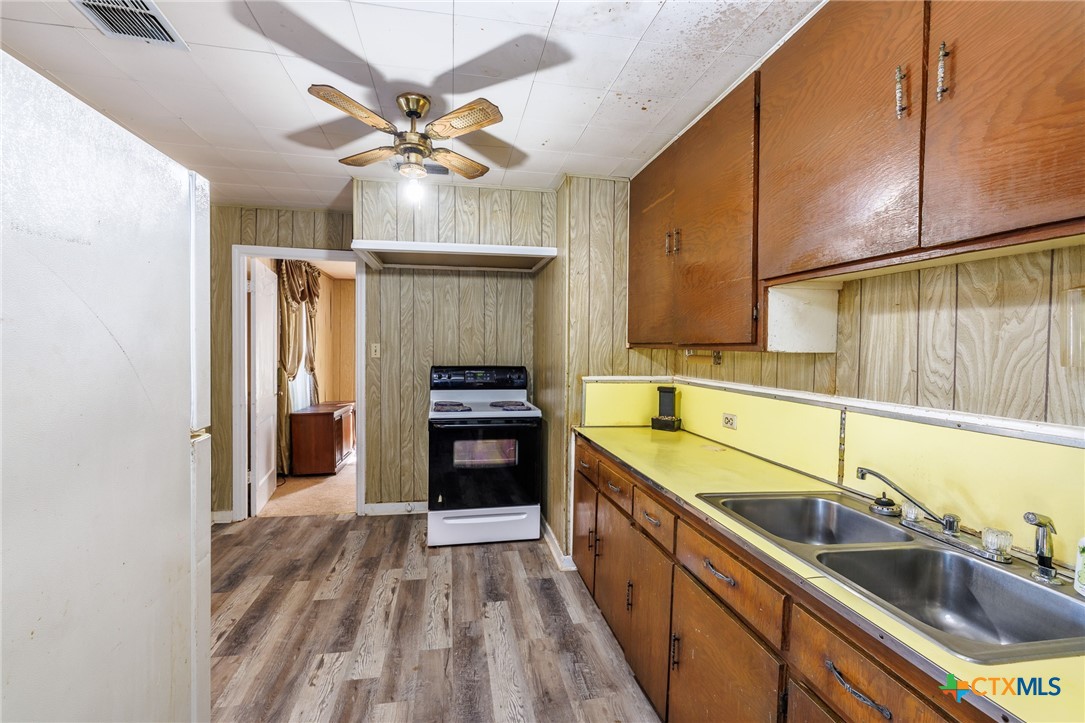 921 Robertson Gonzales, TX 78629 - Photo 7 of 31 a kitchen with stainless steel appliances a sink stove and refrigerator