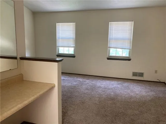 an empty room with closet and wooden door