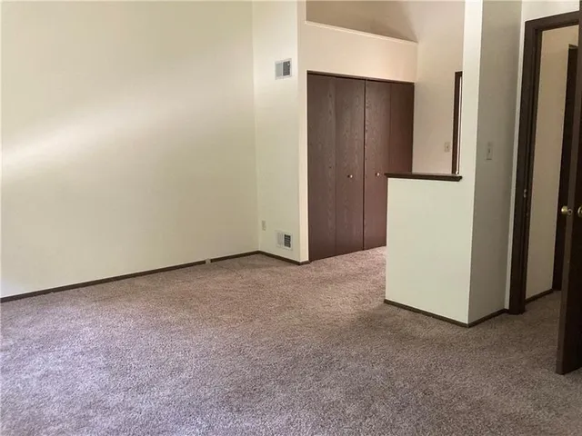 an empty room with closet and window
