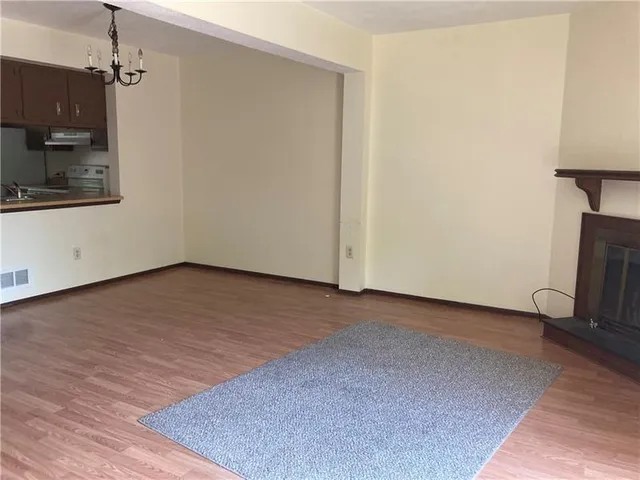a view of a room with wooden floor and a cabinet