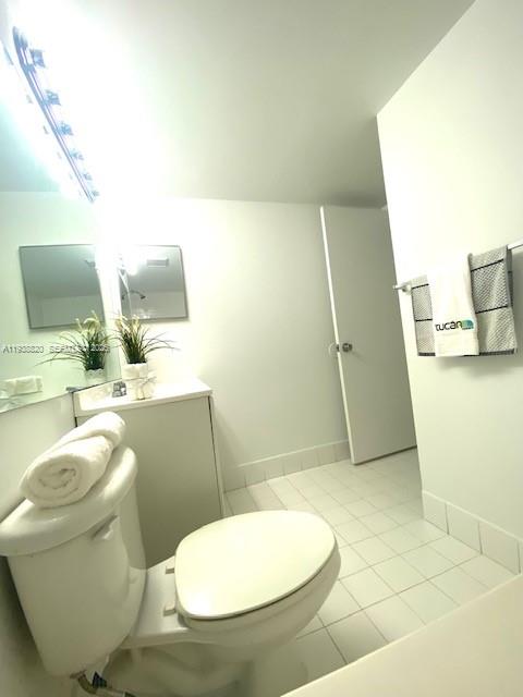 2061 Renaissance Boulevard, Unit 204 Miramar, FL 33025 - Photo 12 of 30 a bathroom with a toilet and a mirror