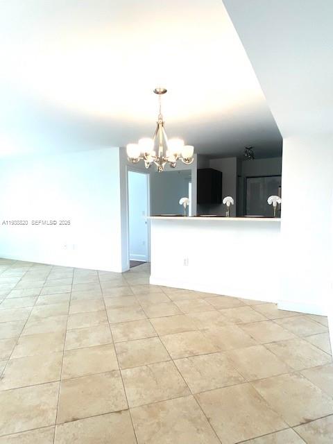 2061 Renaissance Boulevard, Unit 204 Miramar, FL 33025 - Photo 25 of 30 a view of a hallway with a chandelier
