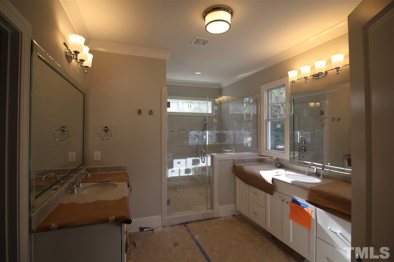 2705 1/2 Gordon Street Raleigh, NC 27608 - Photo 12 of 25 a bathroom with a double vanity sink and mirror with shower