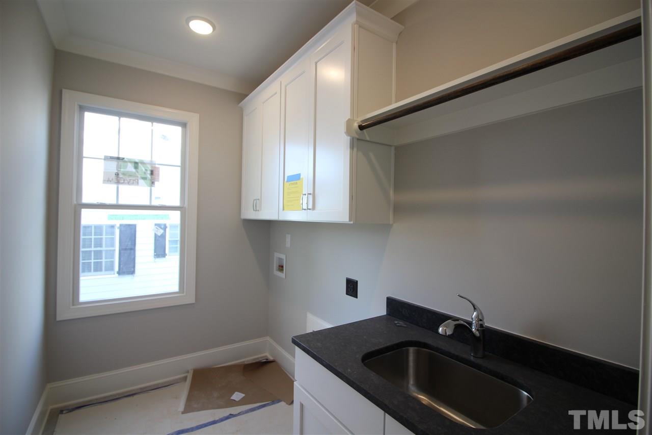 2705 1/2 Gordon Street Raleigh, NC 27608 - Photo 20 of 25 a kitchen with a sink cabinets and a window