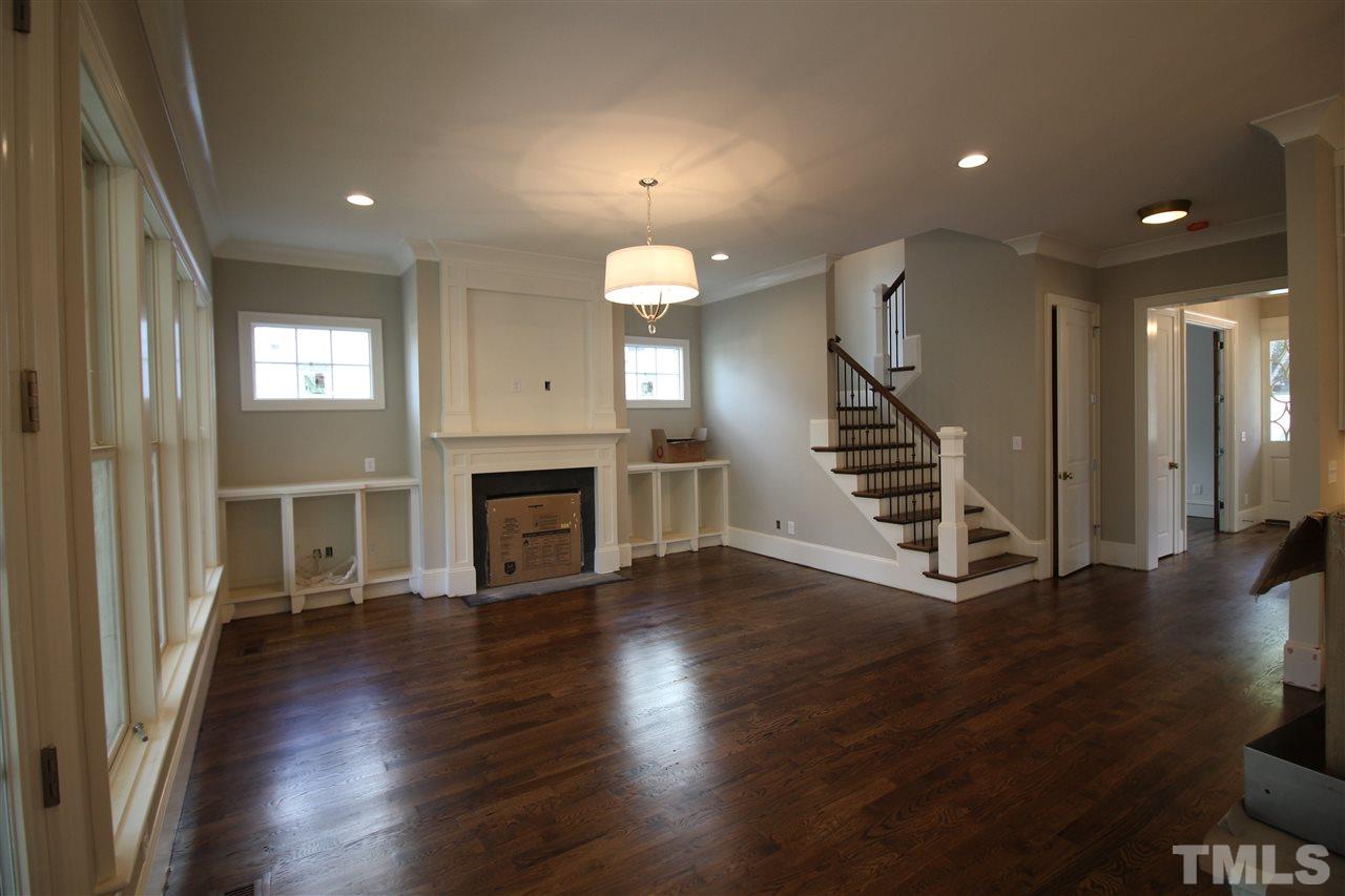2705 1/2 Gordon Street Raleigh, NC 27608 - Photo 5 of 25 an empty room with wooden floor fireplace and windows
