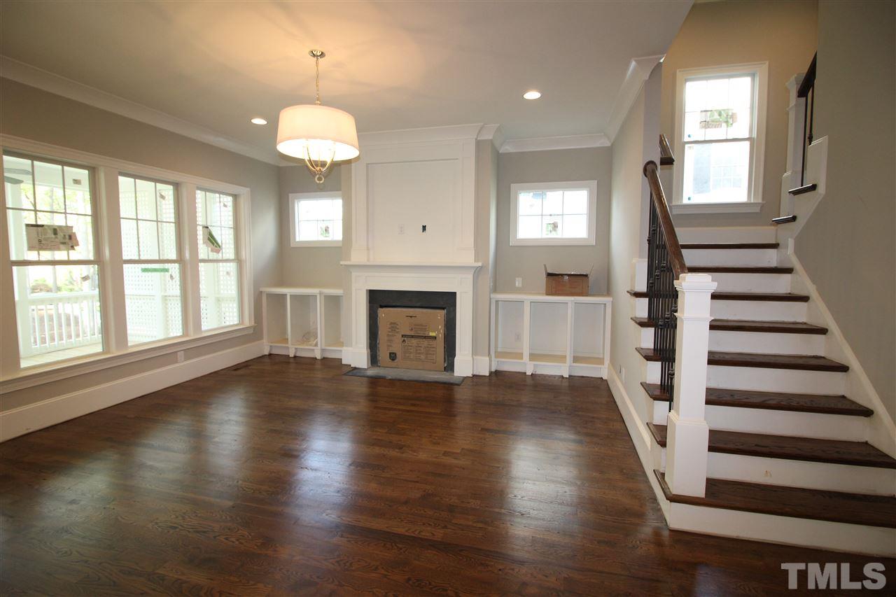 2705 1/2 Gordon Street Raleigh, NC 27608 - Photo 9 of 25 an empty room with wooden floor fireplace and windows
