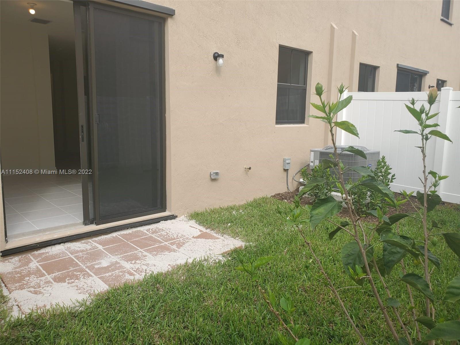 3326 West 112th Street, Unit 3326 Hialeah, FL 33018 - Photo 11 of 25 a backyard of a house with seating space