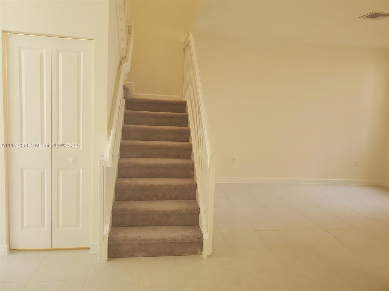 3326 West 112th Street, Unit 3326 Hialeah, FL 33018 - Photo 13 of 25 a view of staircase with white walls