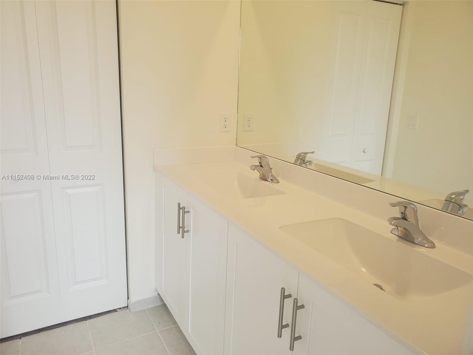 3326 West 112th Street, Unit 3326 Hialeah, FL 33018 - Photo 18 of 25 a bathroom with a sink and shower