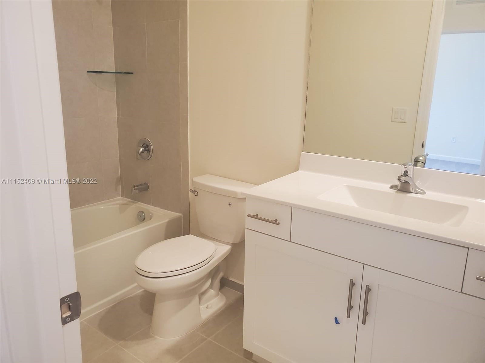 3326 West 112th Street, Unit 3326 Hialeah, FL 33018 - Photo 20 of 25 a bathroom with a sink toilet and shower