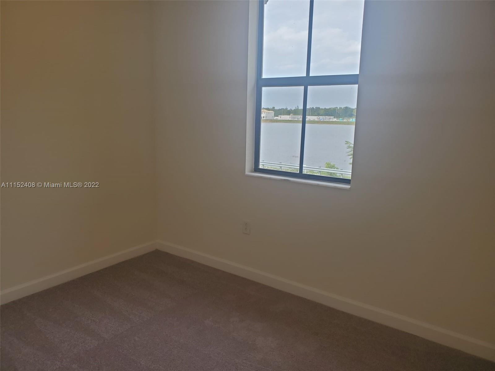 3326 West 112th Street, Unit 3326 Hialeah, FL 33018 - Photo 25 of 25 an empty room with a window