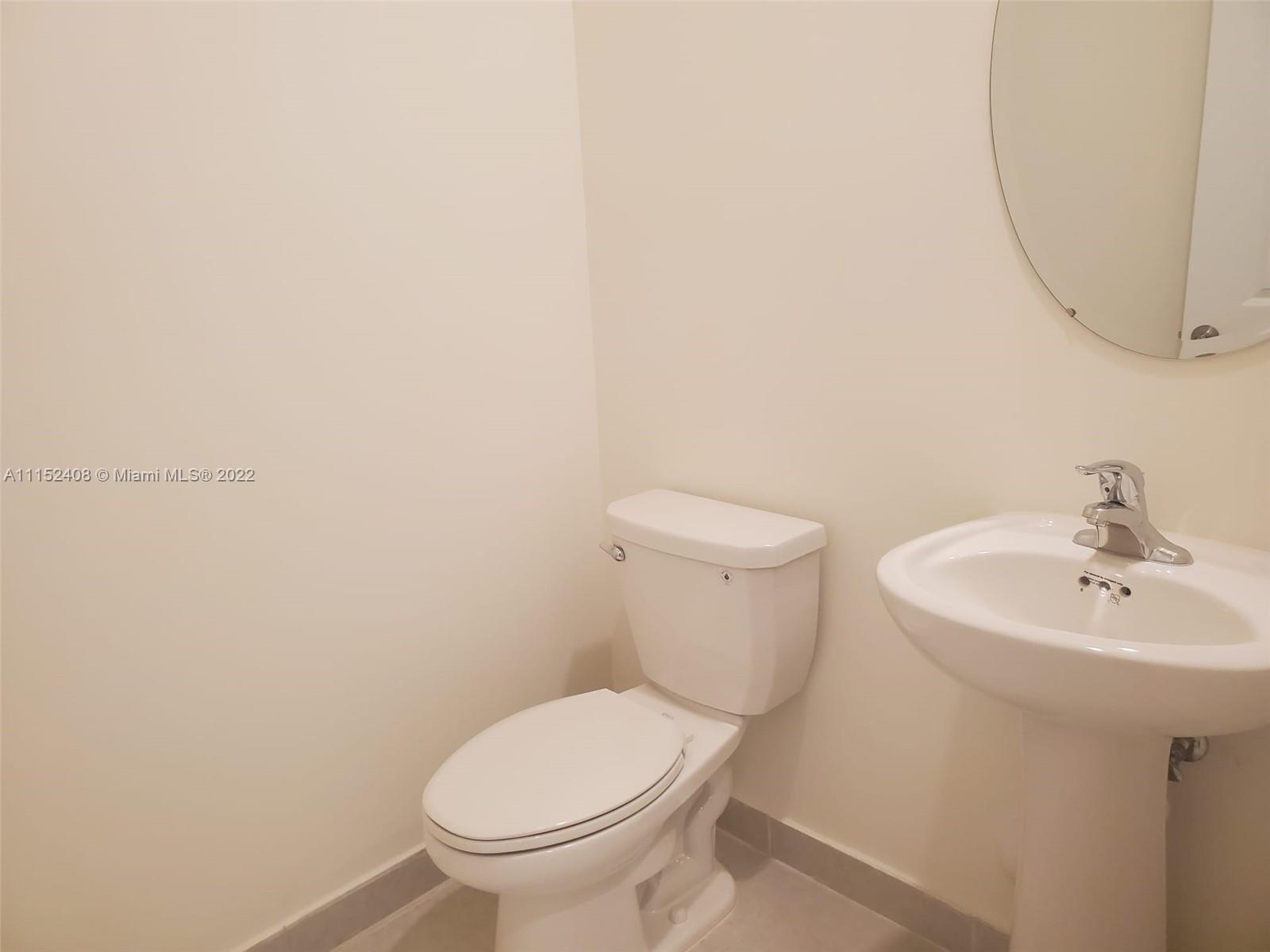 3326 West 112th Street, Unit 3326 Hialeah, FL 33018 - Photo 6 of 25 a white toilet sitting next to a white sink