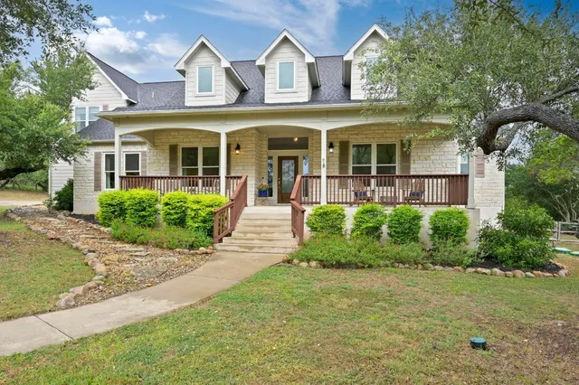 front view of a brick house with a yard