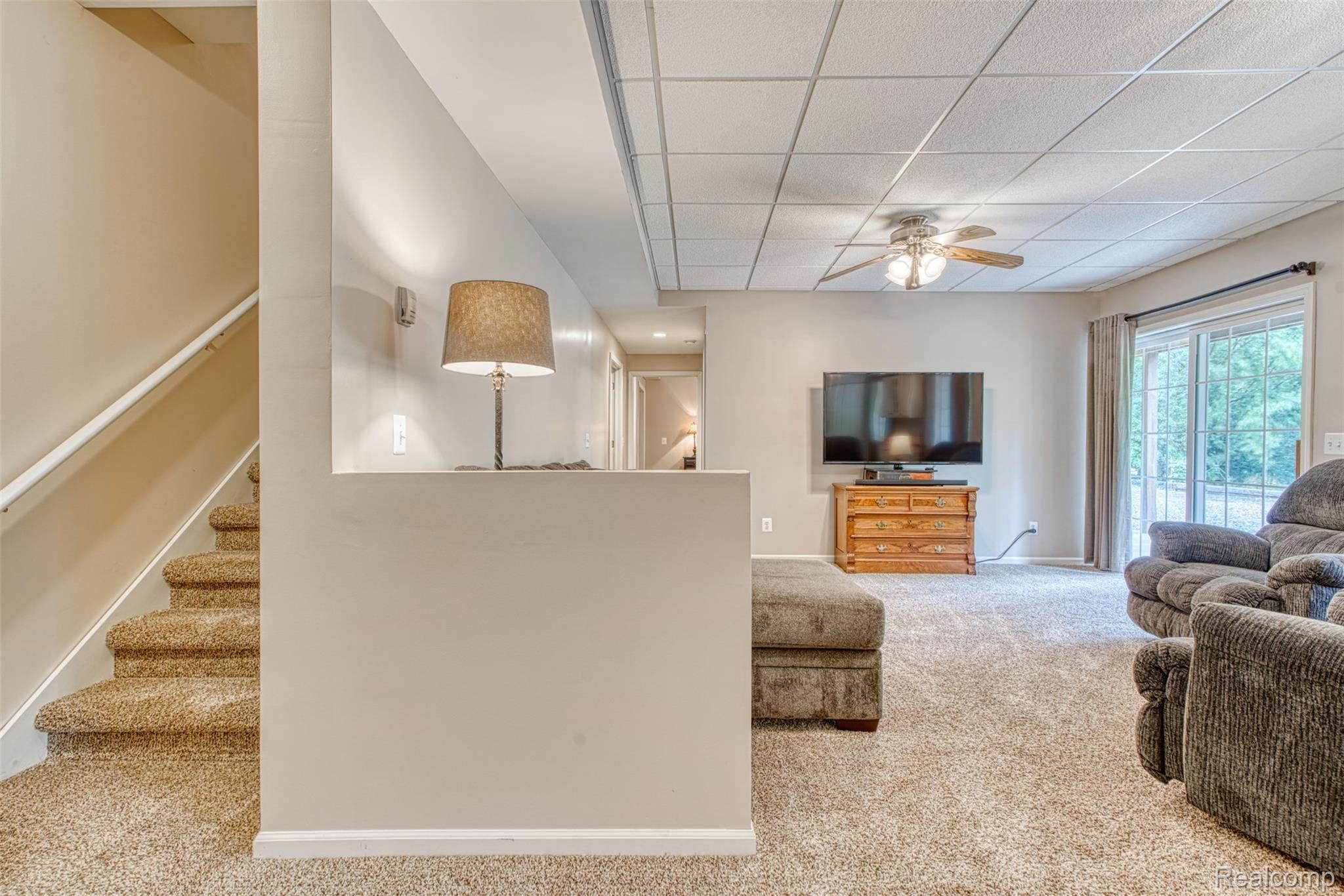 7016 West Lange Road Fowlerville, MI 48836 - Photo 35 of 61 LIVING ROOM IN THE BASEMENT W/ SLIDER TO OUTSIDE PATIO...