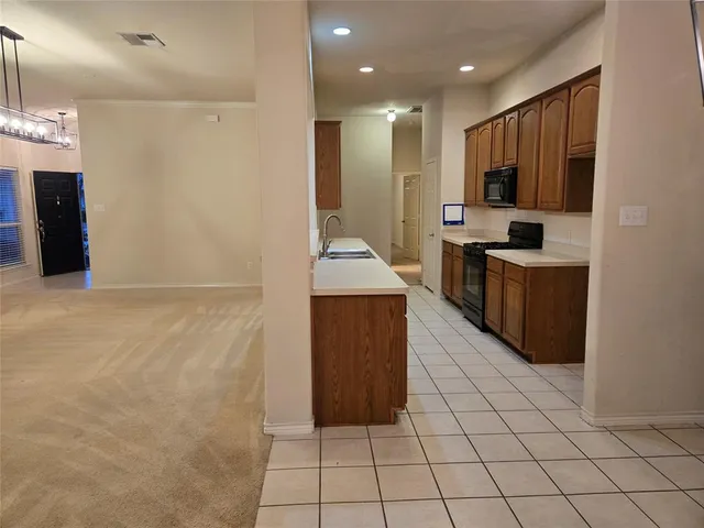 a kitchen with cabinets and stainless steel appliances