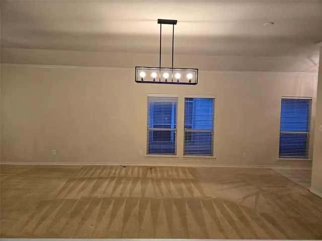 a view of wooden floor and chandelier in a room