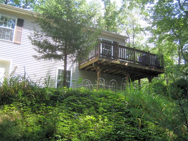 207 Whiley Road Groton, MA 01450 - Photo 4 of 14 a view of a house with a small yard and a large tree