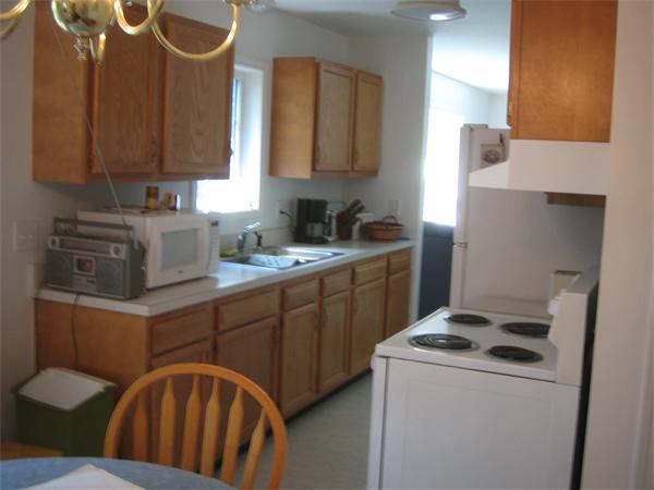 207 Whiley Road Groton, MA 01450 - Photo 7 of 14 a kitchen with a stove a sink and a refrigerator
