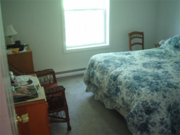 207 Whiley Road Groton, MA 01450 - Photo 9 of 14 a bedroom with a bed chair and window