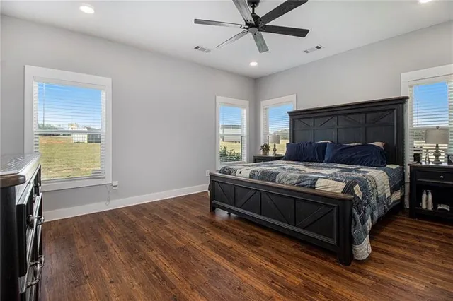 a bedroom with a bed and wooden floor