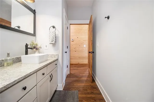 a bathroom with a granite countertop sink and a mirror