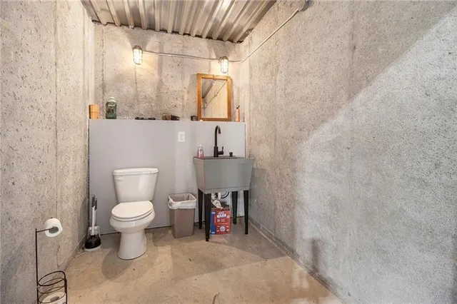 a bathroom with a toilet sink and a mirror