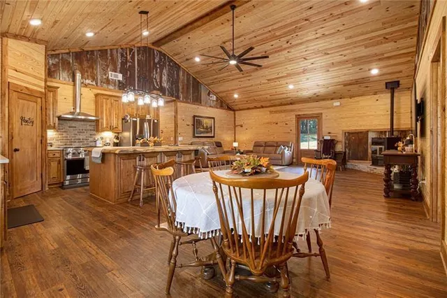 a dining room with furniture a chandelier and wooden floor