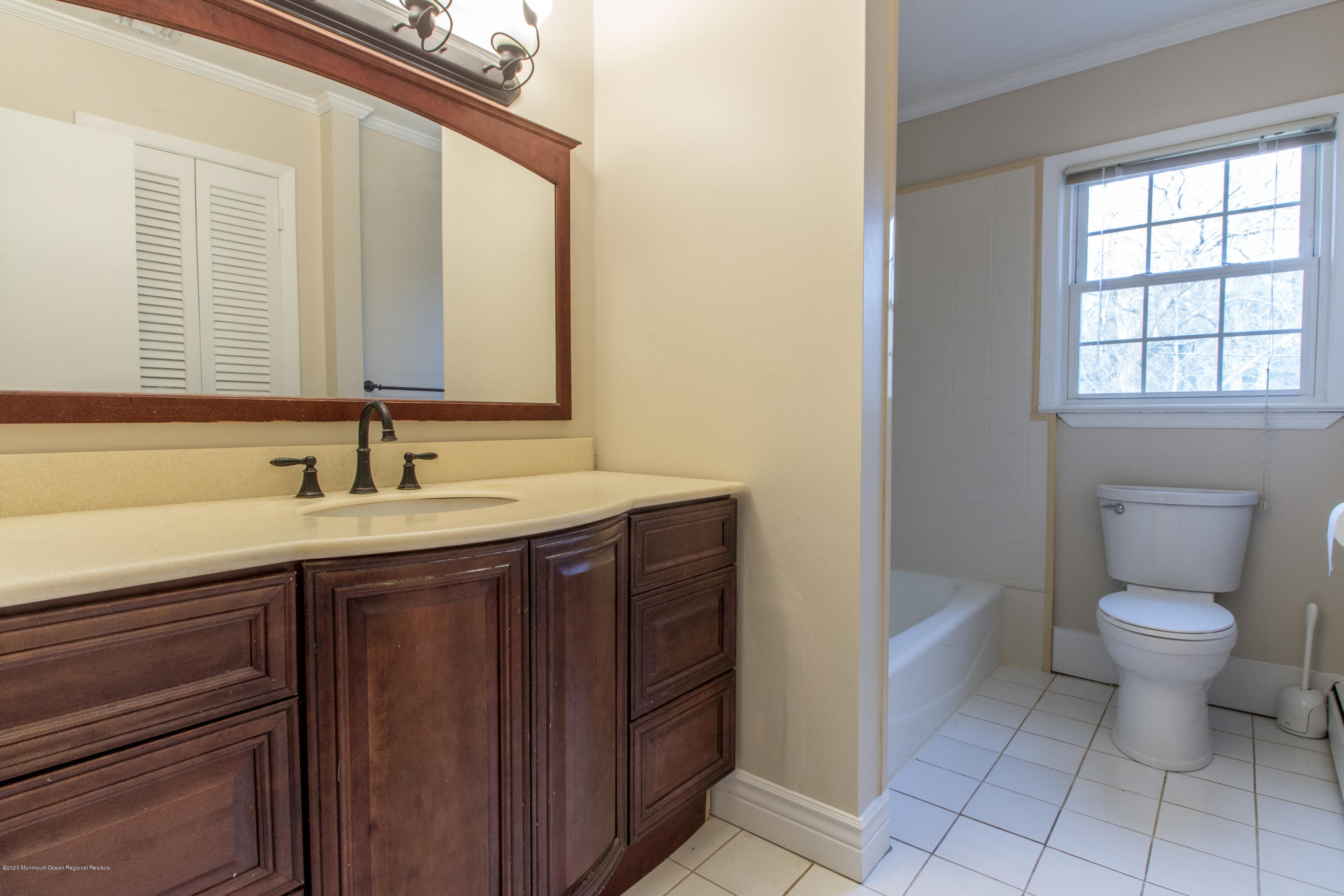 14 Hill Road Lincroft, NJ 07738 - Photo 23 of 29 a bathroom with a toilet sink and mirror