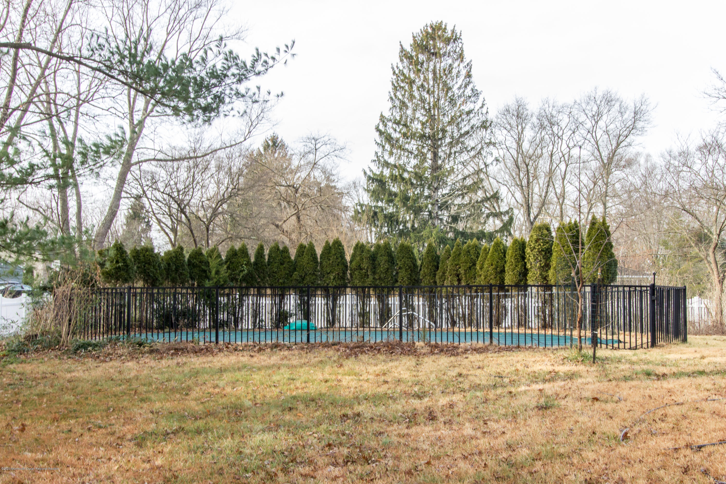 14 Hill Road Lincroft, NJ 07738 - Photo 28 of 29 a view of a yard with large trees and wooden fence