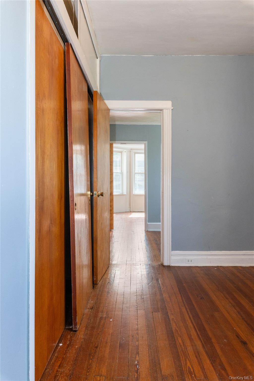 82-72 88th Place Queens, NY 11421 - Photo 15 of 26 a view of a hallway with wooden floor and closet