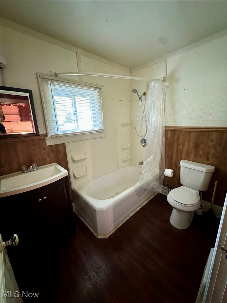 1325 Walnut Road Southeast Massillon, OH 44646 - Photo 19 of 34 Full bathroom with shower / bath combination with curtain, vanity, wood walls, hardwood / wood-style flooring, and toilet
